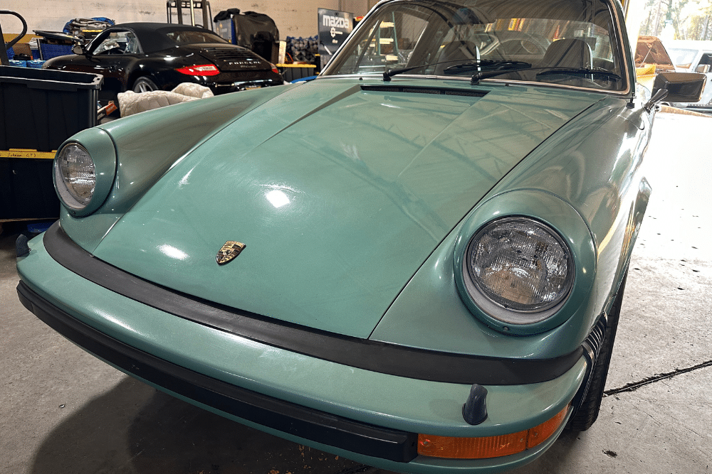 headlights, auto repair in Gainesville, GA at Atlanta Speedwerks. Close-up image of a vintage Porsche 911 featuring well-maintained headlights.