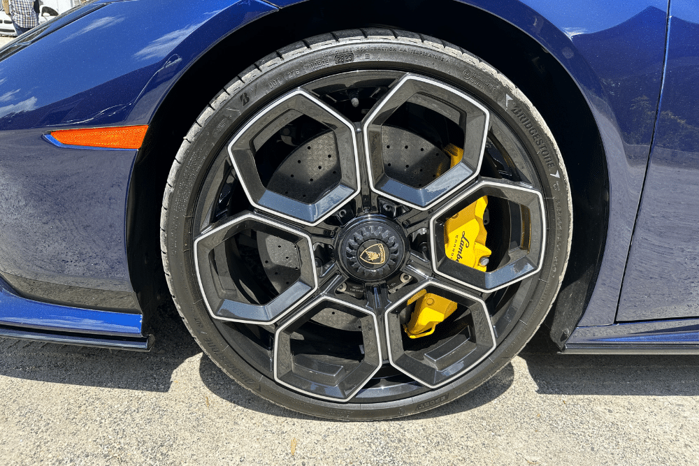 wheels skidding, auto repair in Gainesville, GA at Atlanta Speedwerks. Image of a high-performance Lamborghini wheel with sleek black rims and yellow calipers, showcasing expert care for luxury vehicle wheels and braking systems.