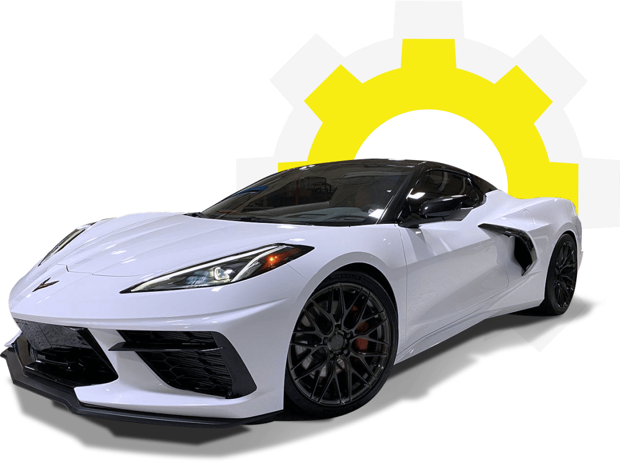 European auto repair shop specialists in Gainsville, GA. with Atlanta Speedwerks. A sleek white sports car with a black roof and aggressive design is parked in front of a large gear-shaped icon, partially seen in white and yellow.