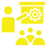 Clip art of a person giving a presentation about a gear to three seated audience members, all in yellow.