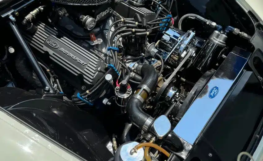 Close-up of a Ford engine inside a vehicle, displaying various components and Ford Motorsport branding.