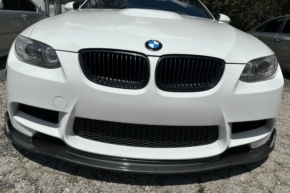 bmw 6 series repair issues, european auto repair in Gainesville, GA at Atlanta Speedwerks. Close-up front view of a white BMW, focusing on the iconic kidney grille and black carbon fiber front lip.