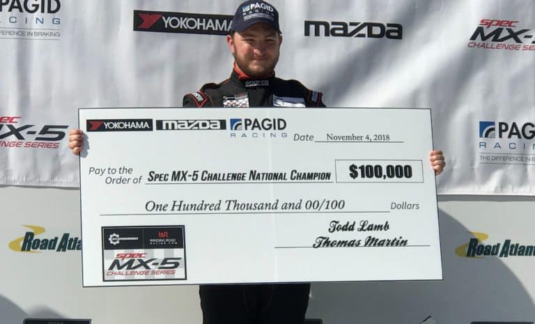 a man holding a large check