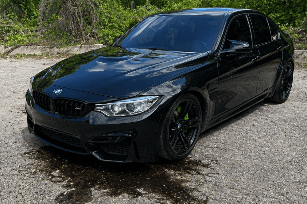 BMW issues, European auto repair in Gainesville, GA, at Atlanta Speedwerks. Image of BMW with visible oil leak underneath, highlighting the need for prompt diagnostics and precision repair to protect engine performance and prevent costly damage.