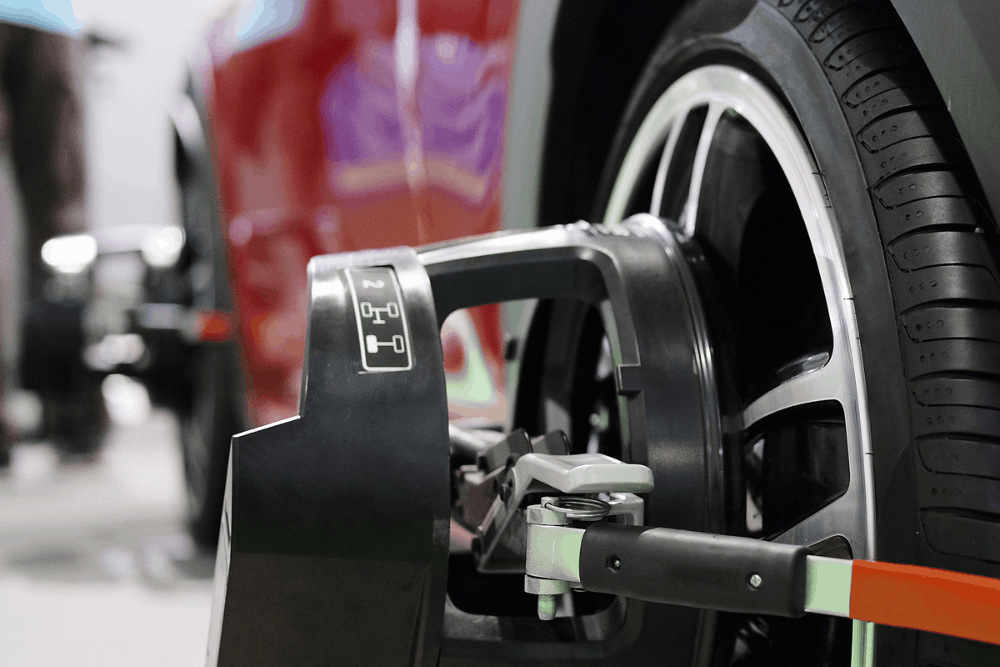 Wheel alignment, auto repair in Gainesville, GA at Atlanta Speedwerks. Image of alignment equipment attached to a vehicle wheel during service.