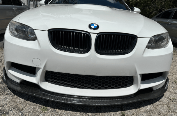 bmw 6 series repair issues, european auto repair in Gainesville, GA at Atlanta Speedwerks. Close-up front view of a white BMW, focusing on the iconic kidney grille and black carbon fiber front lip.