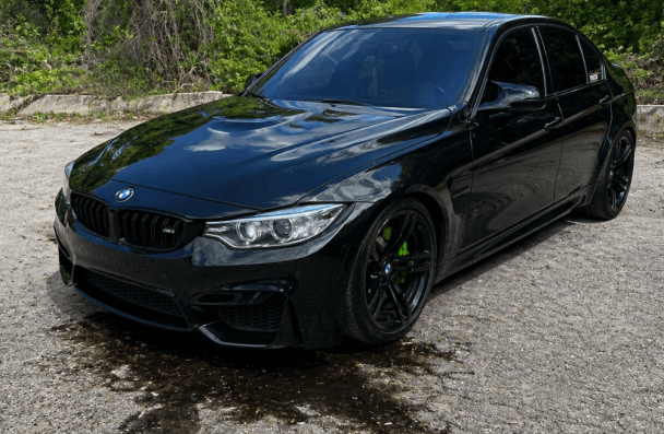 BMW issues, European auto repair in Gainesville, GA, at Atlanta Speedwerks. Image of BMW with visible oil leak underneath, highlighting the need for prompt diagnostics and precision repair to protect engine performance and prevent costly damage.