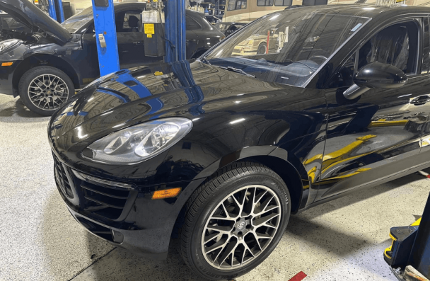 Porsche performance problems, European auto repair in Gainesville, GA, at Atlanta Speedwerks. Image of black Porsche SUVs inside the shop during professional diagnostics, maintenance, and high-performance European auto repair services.