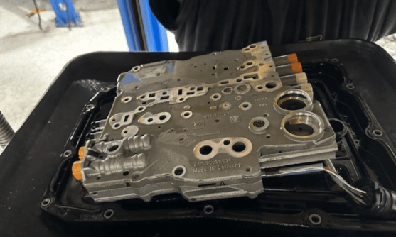 Image of a technician inspecting a transmission component, showcasing the shop’s focus on accuracy and quality in European transmission repair.