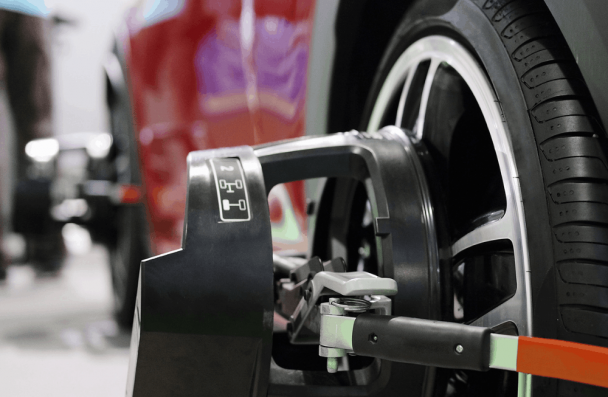 Wheel alignment, auto repair in Gainesville, GA at Atlanta Speedwerks. Image of alignment equipment attached to a vehicle wheel during service.