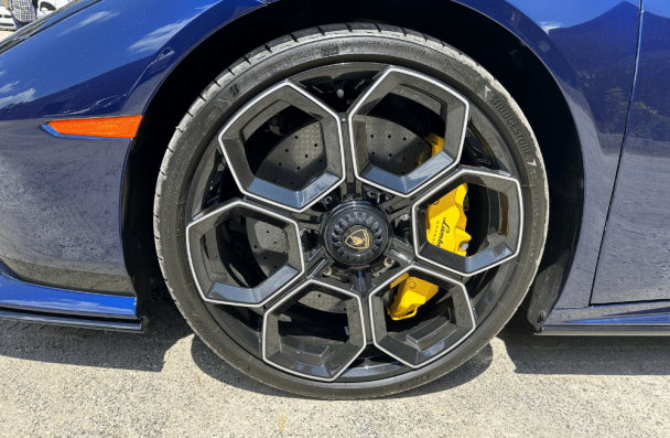 wheels skidding, auto repair in Gainesville, GA at Atlanta Speedwerks. Image of a high-performance Lamborghini wheel with sleek black rims and yellow calipers, showcasing expert care for luxury vehicle wheels and braking systems.