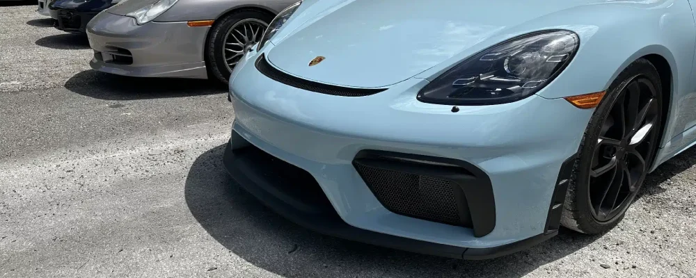 Porsche repair and maintenance in Gainesville, GA by Atlanta Speedwerks. Image of a light blue Porsche Cayman parked, showcasing the car's sleek design and suitability for daily driving with proper care and maintenance.