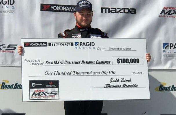 a man holding a large check