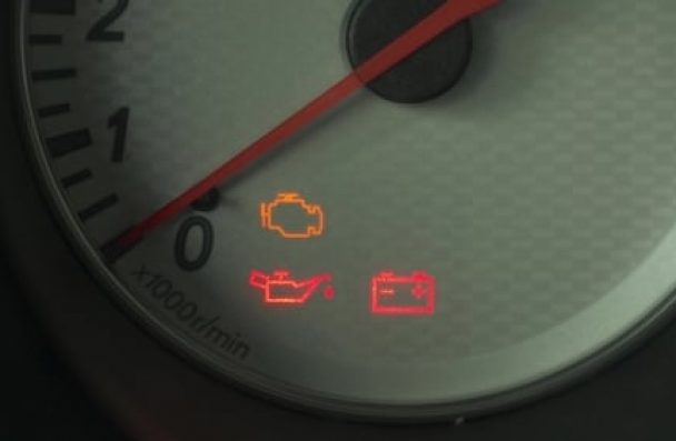 Check engine light on in Gainsville, GA, with Atlanta Speedwerks. Image of check engine light and other dash lights illuminated on car speedometer signaling that it need diagnostics