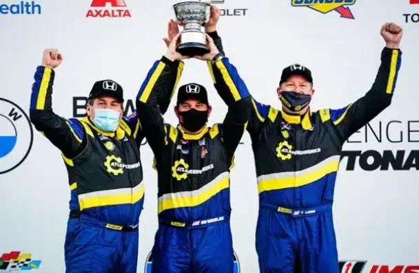 a group of men wearing face masks and holding up a trophy